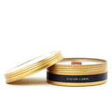 gold tin filled with 100% soy candle with a wooden wick. scent olive leaf and lemon